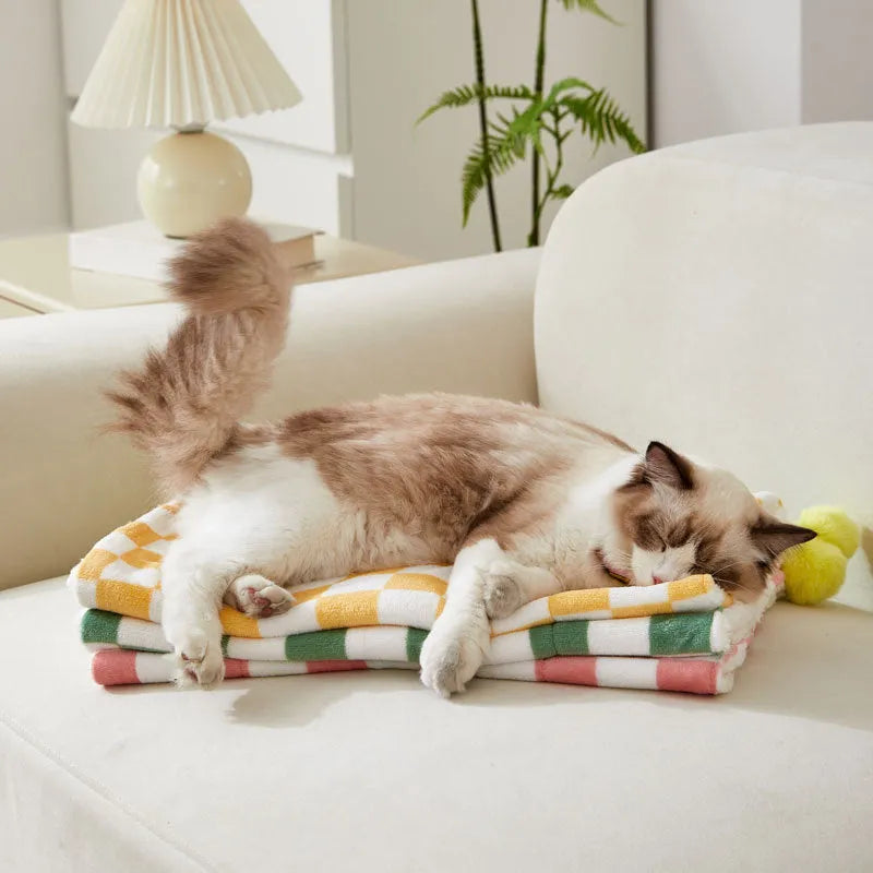 Soft plush pet blanket with plaid pattern and fur ball decoration for cats and dogs