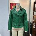 Black punk-style short jacket with a Peter Pan collar, lapel, and waist belt on a hanger.