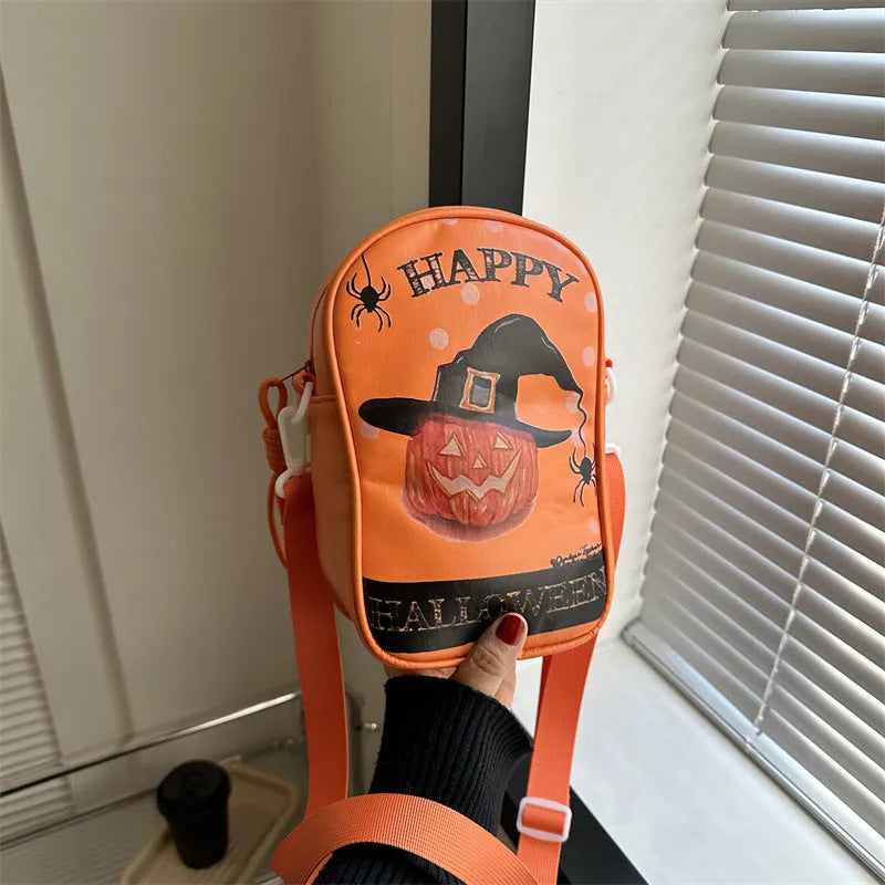 Black Halloween crossbody bag with orange pumpkin, white ghost, and black bat print, showing front zip and adjustable strap.