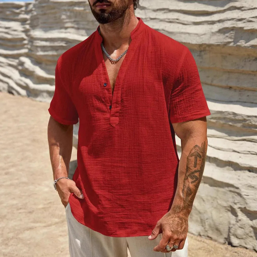 Man wearing a thin light blue stand collar short-sleeved casual shirt.