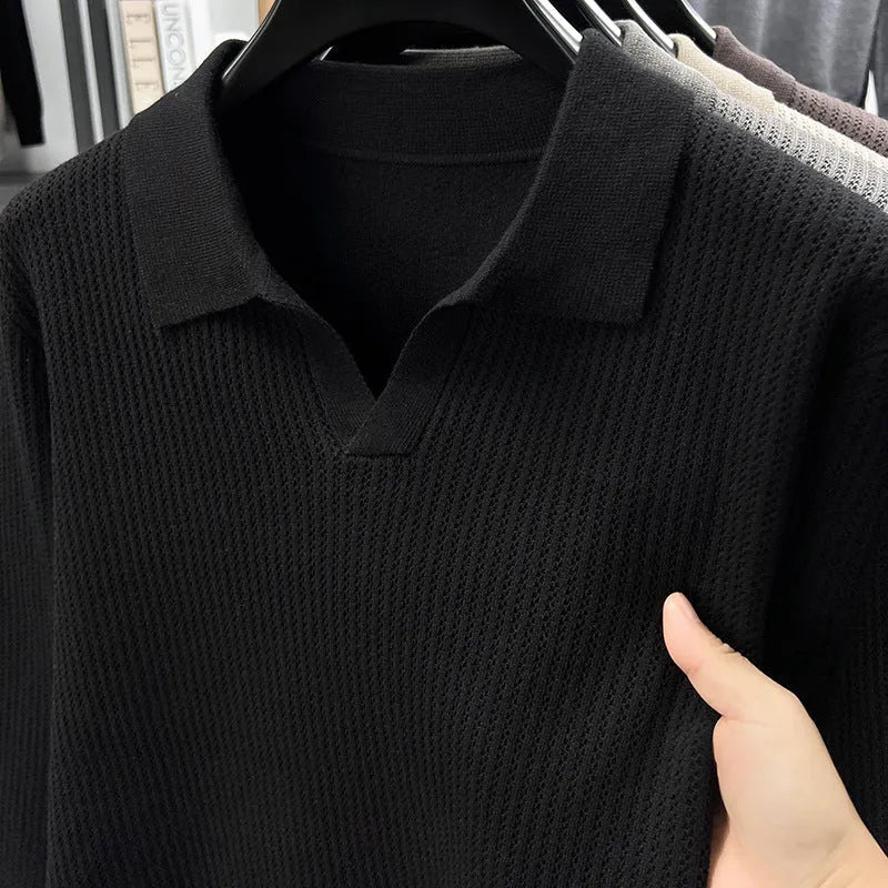 Man wearing a loose green pullover sweater, a casual autumn bottoming layer.