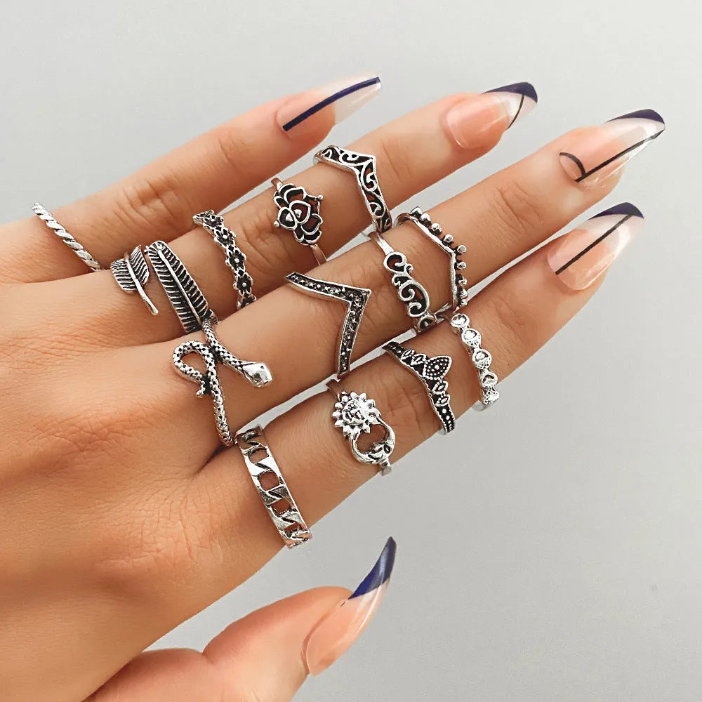 Alloy ring set with butterfly and snake retro geometric designs on display