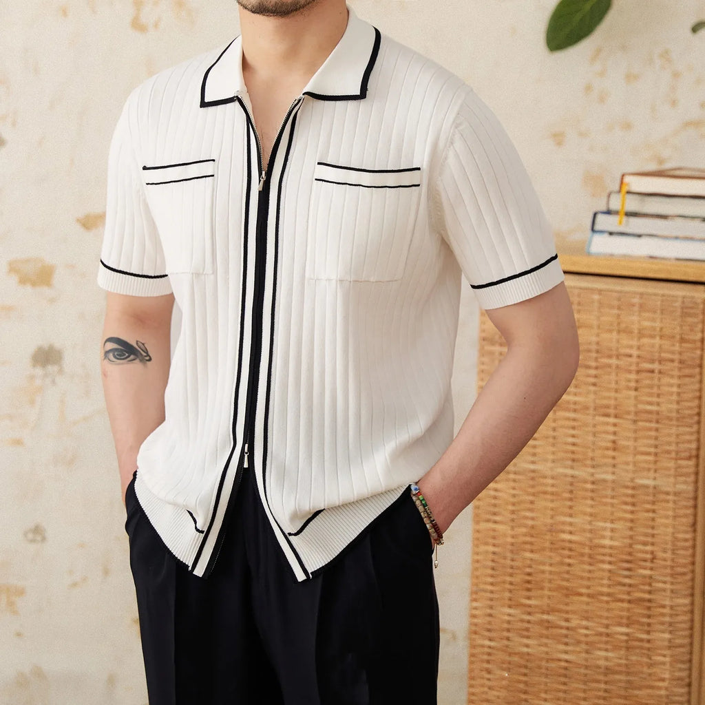 A black slim fit polo shirt with a lapel collar and short sleeves on a hanger.