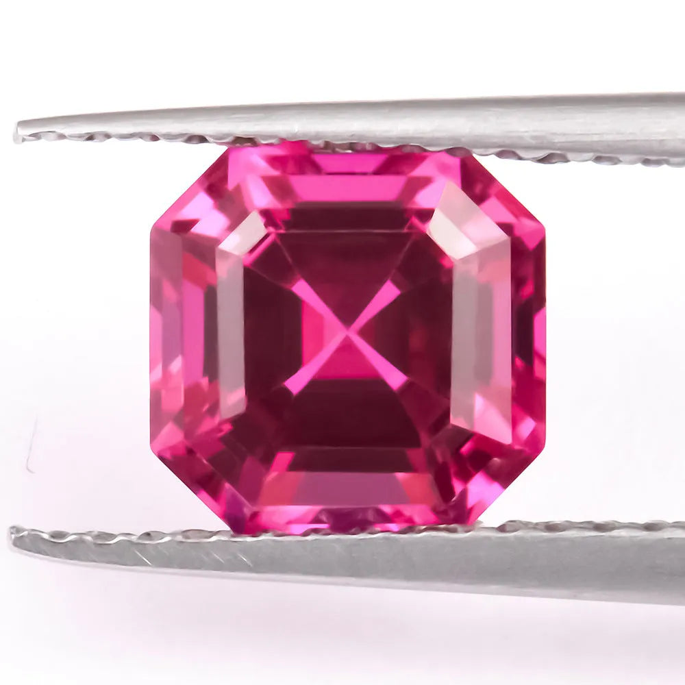 A loose, faceted artificial ruby gemstone in a deep pigeon blood red colour.