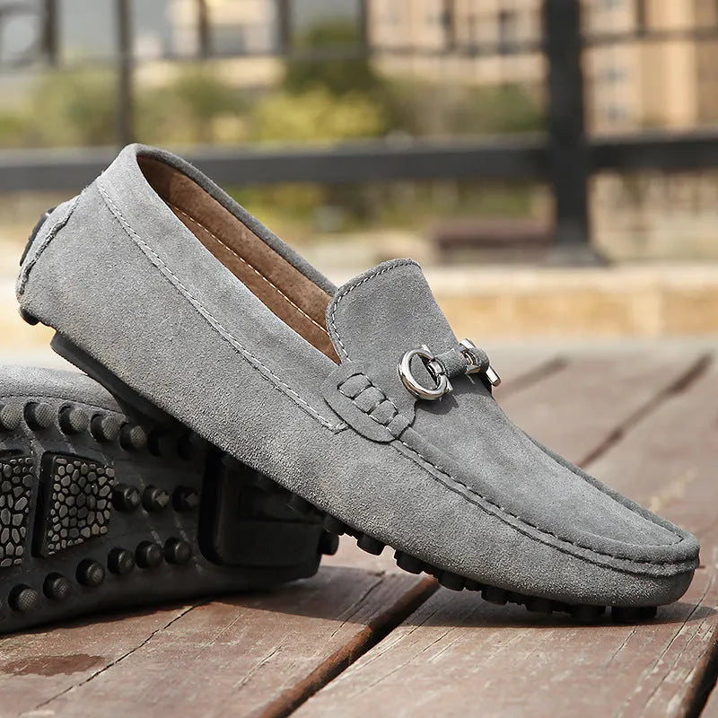 Men's black matte cowhide slip-on shoe with square toe and visible stitching on a plain background.