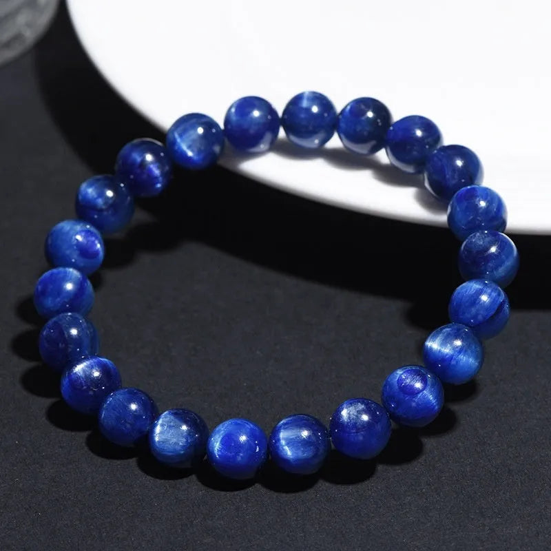 Natural blue grade 7A crystal bracelet with geometric bead and Ruyi charm on wrist.