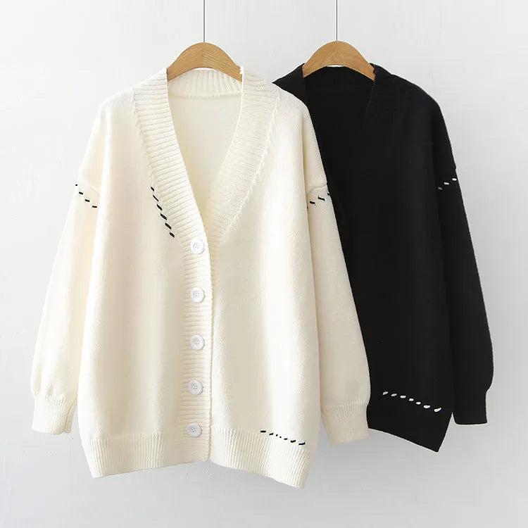 Women's loose fit knitted cardigan coat in black or white, long sleeve design