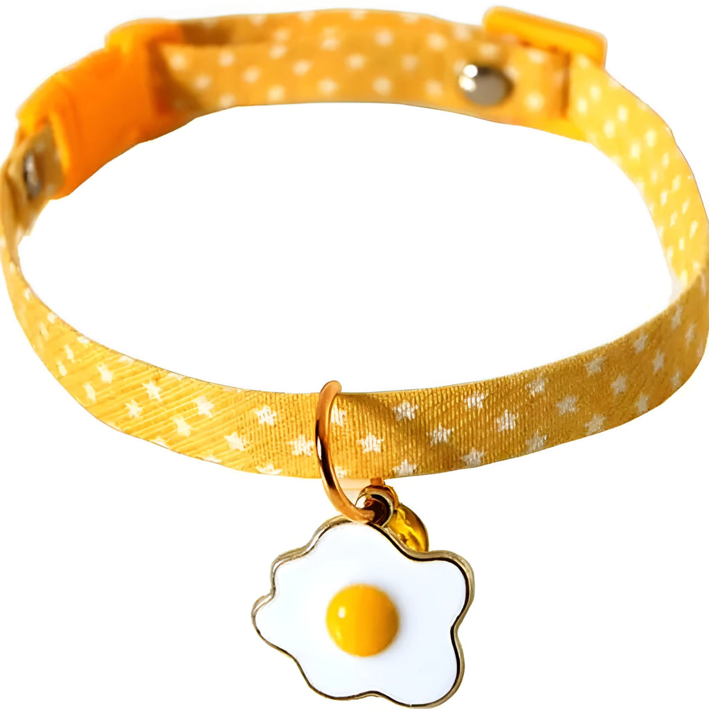 Adjustable green pet collar with a metal bell and a matching bow tie on a small dog.