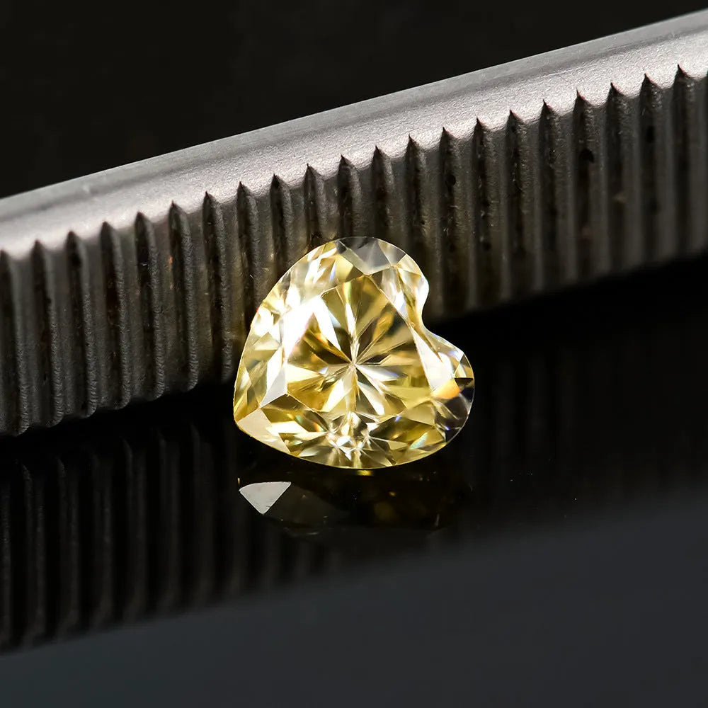 Heart-shaped moissanite gemstone in lemon yellow colour, shown alongside other colour options.