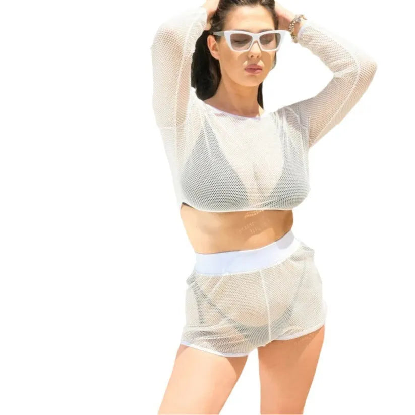 White transparent strappy swimsuit top and matching skirt laid flat for beachwear.