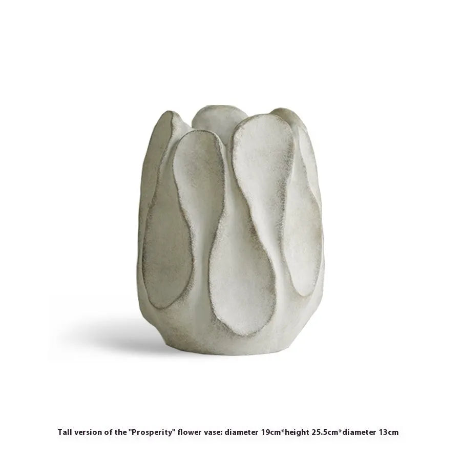 Irregular shaped handcrafted ceramic vase on a wooden surface, showing its artisanal form.