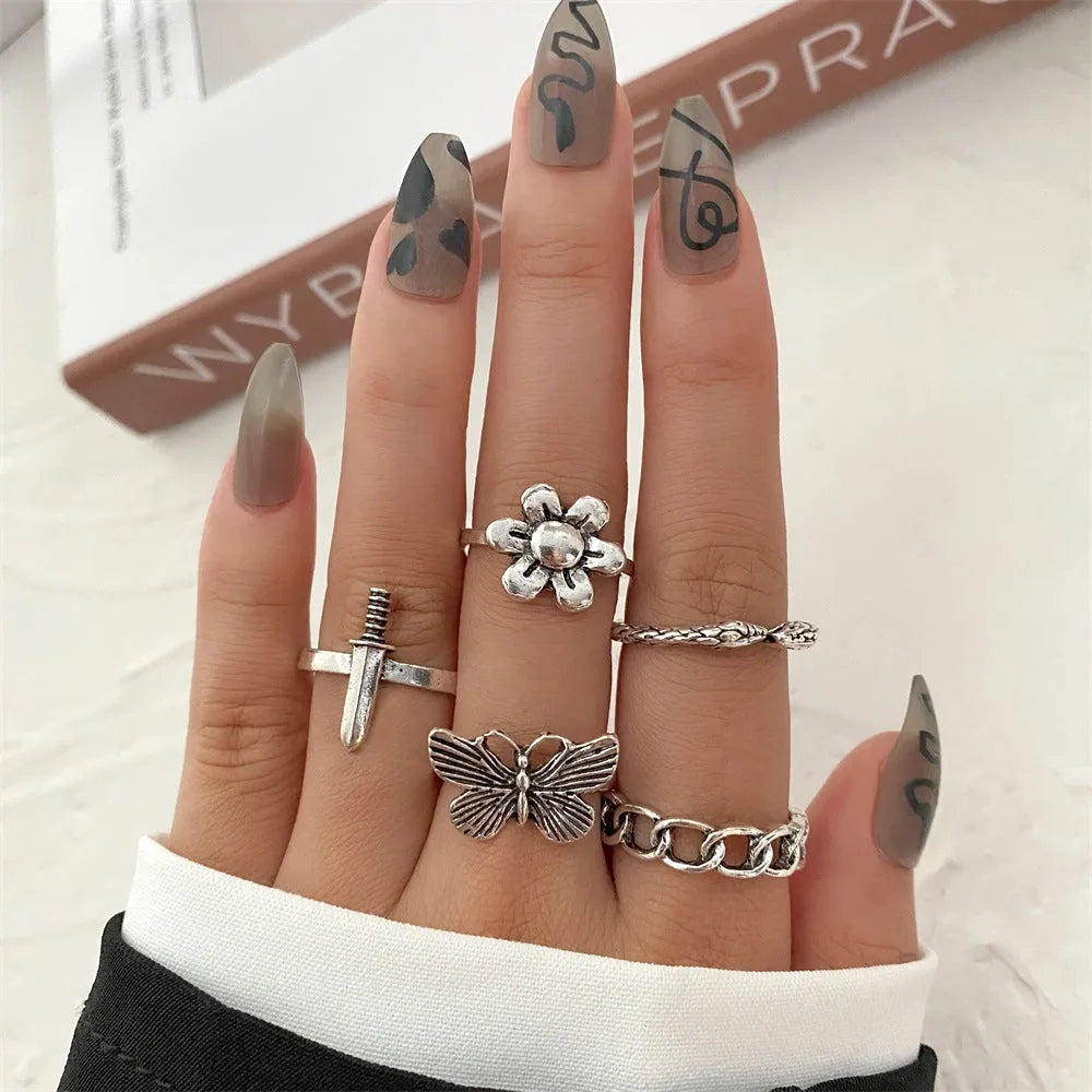 Alloy ring set with butterfly and snake retro geometric designs on display