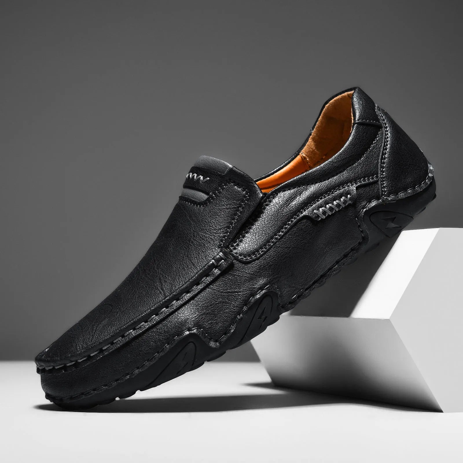 Casual slip-on shoes in multiple colours with a microfiber upper and flat rubber sole.