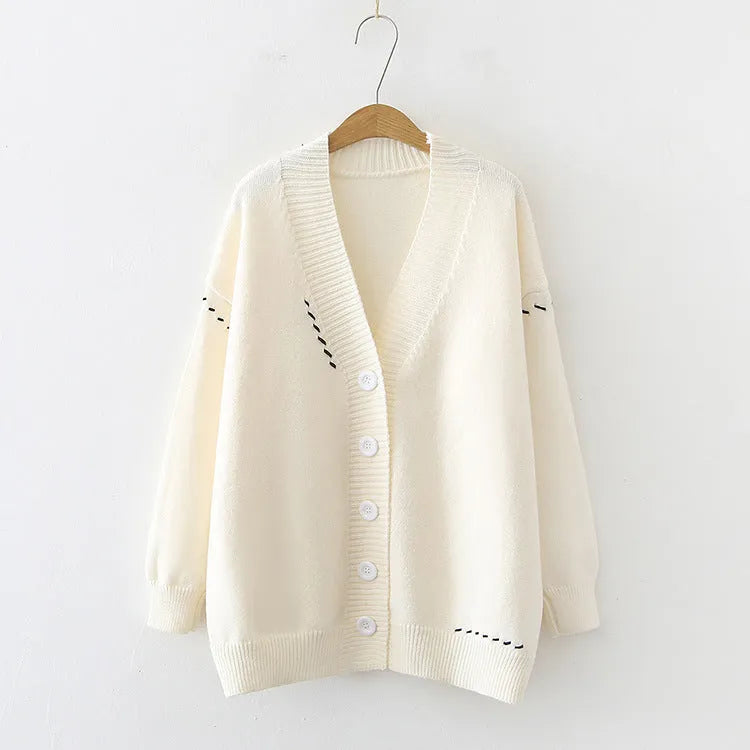 Women's loose fit knitted cardigan coat in black or white, long sleeve design