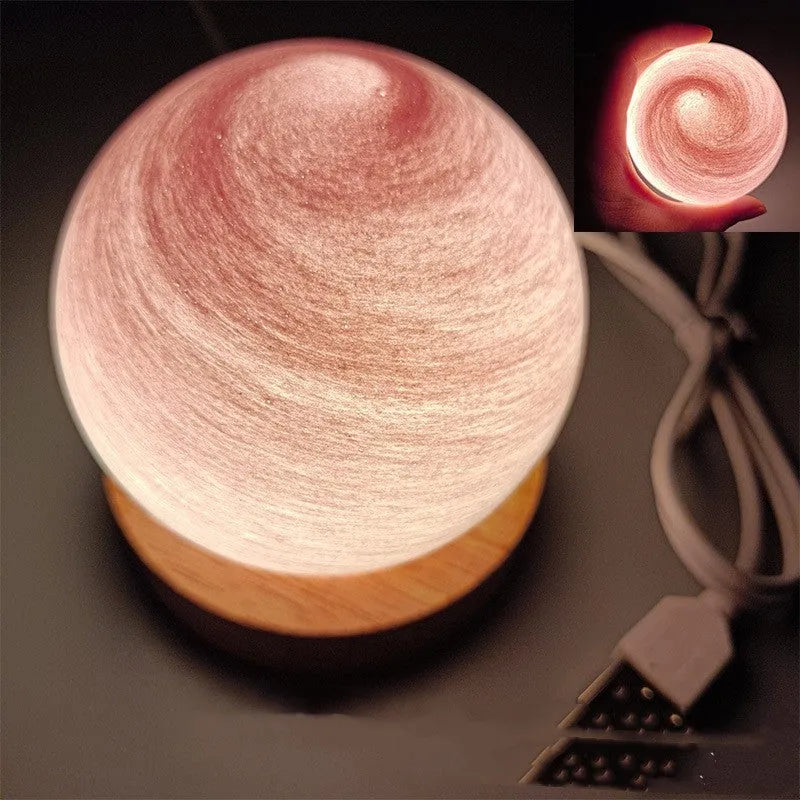 Modern planet-shaped USB night light on its base with dimmable multi-colour glow