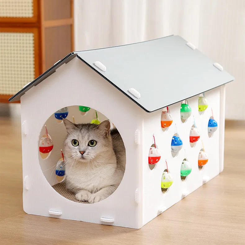 Durable plastic cat scratch board with an attached tunnel and a dangling bell ball toy on a neutral carpet.