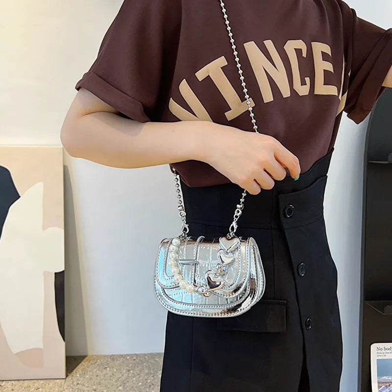 Silver women's PU leather crossbody bag in a horizontal square tote saddle shape with a single strap.