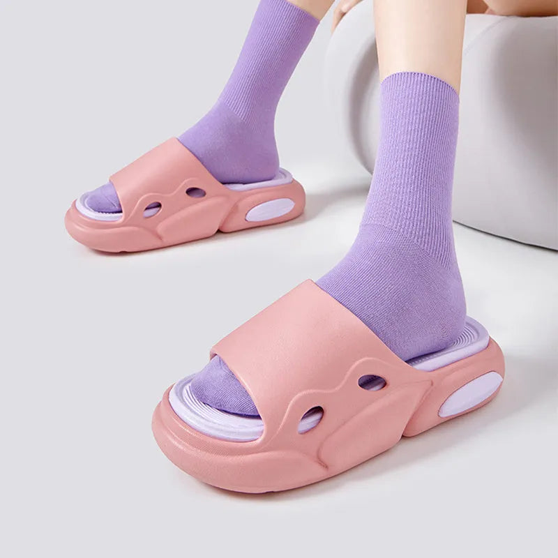 Two-colour EVA slippers with thick sole and leather lining in pink and purple.