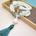 White jade bodhi 108-bead bracelet showing natural stone texture and bead details.