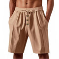 Men's loose straight-leg summer shorts in light khaki, lying flat on a light background