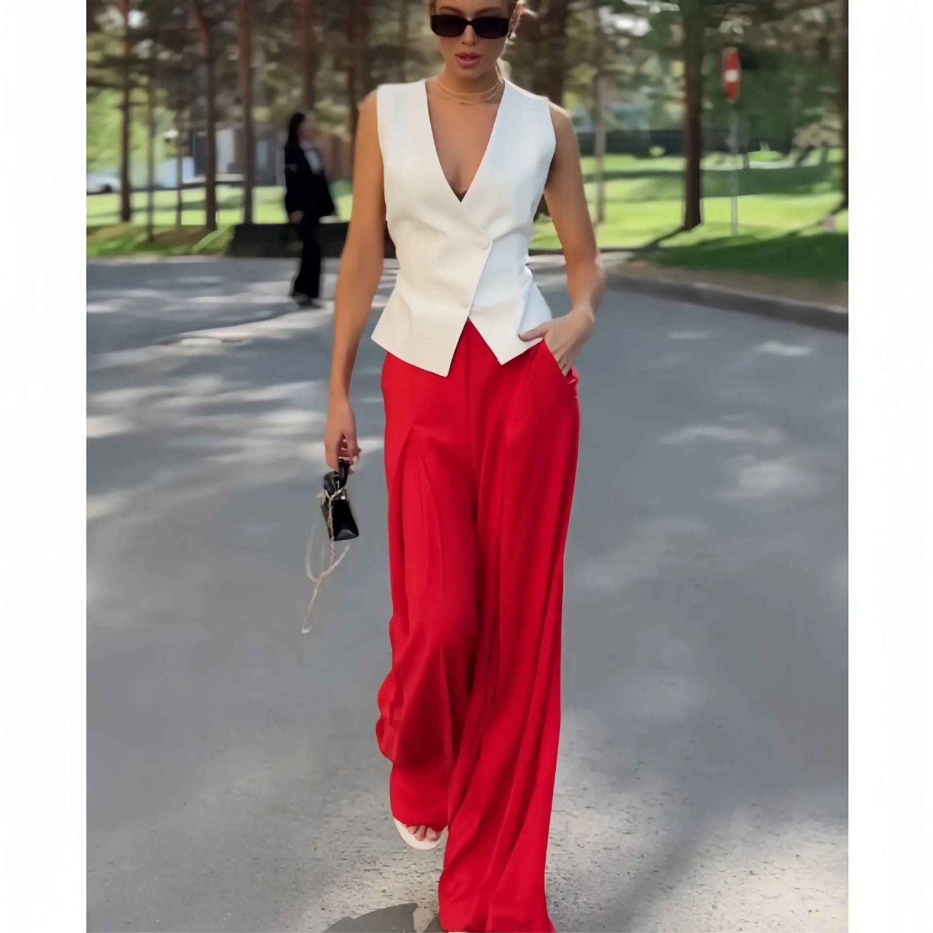 Women's beige polyester two-piece set with sleeveless deep V-neck top and high-waist wide-leg trousers.