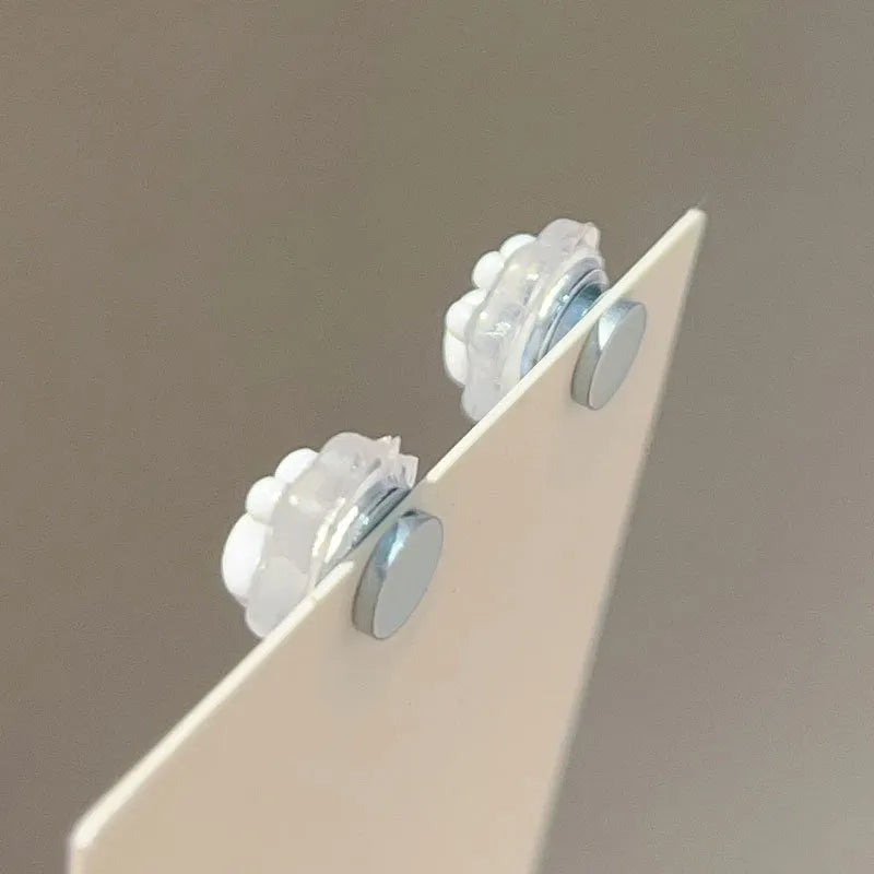 Cat paw magnetic ear clips in transparent pink colour with plastic resin finish, packaged as one pair