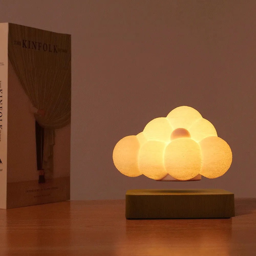 Magnetic levitation cloud lamp floating above base with warm white light, ABS flower-shaped lampshade