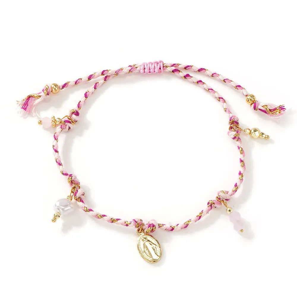 Close-up of a colourful hand-woven adjustable bracelet with an ethnic-style strap tag on a wrist.