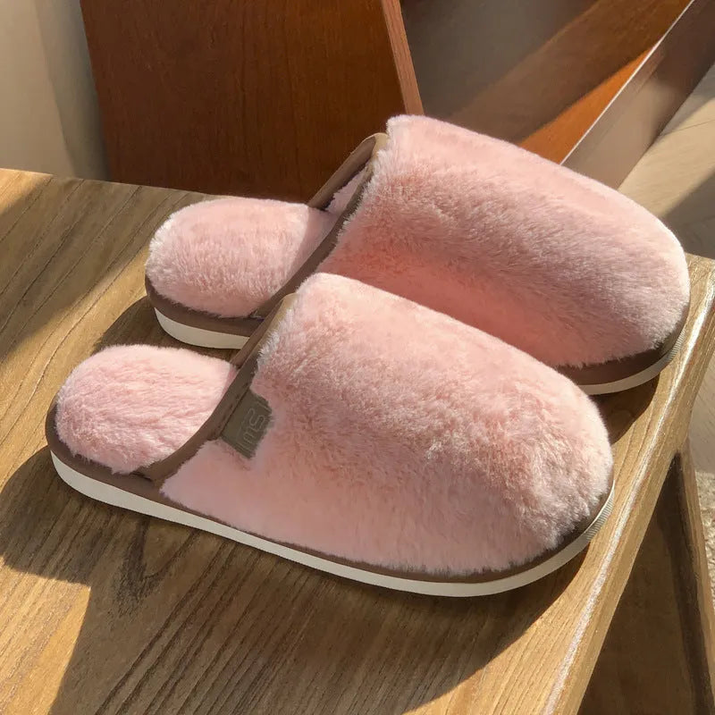 Pair of solid-colour plush PVC slippers with an overshoe design and a textured non-slip sole.