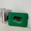 Embroidered animal design laptop sleeve in polyester, shown next to a laptop.