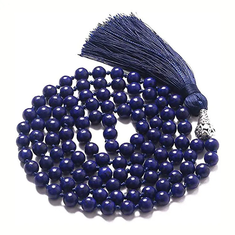 Long agate and amethyst gemstone tassel necklace with geometric pendant on a model.