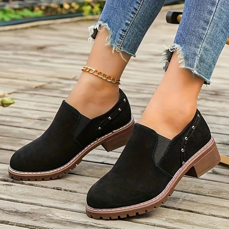 Women's light brown suede ankle boots with a low thick heel and elasticated ankle band.