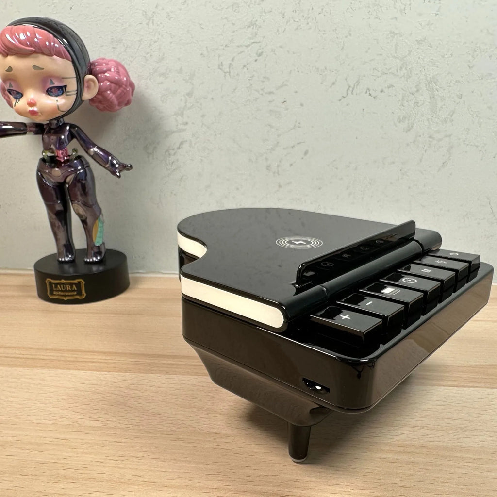 Black multi-function Bluetooth speaker wireless charger and phone holder on a desk