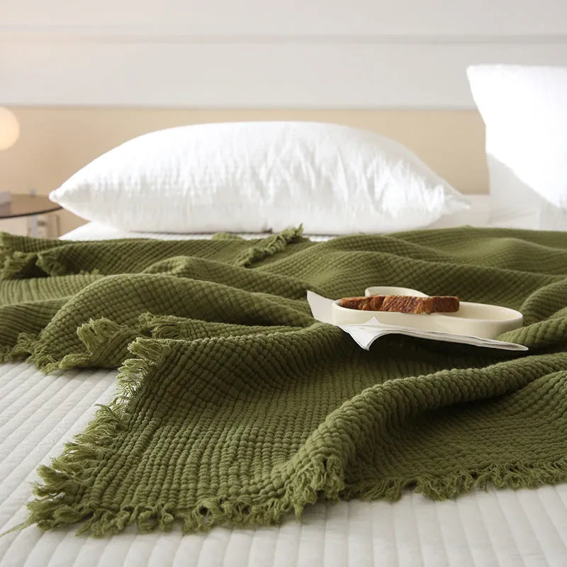 Four-layer gauze cotton blanket with tassel trim in a choice of ten colours and two sizes.