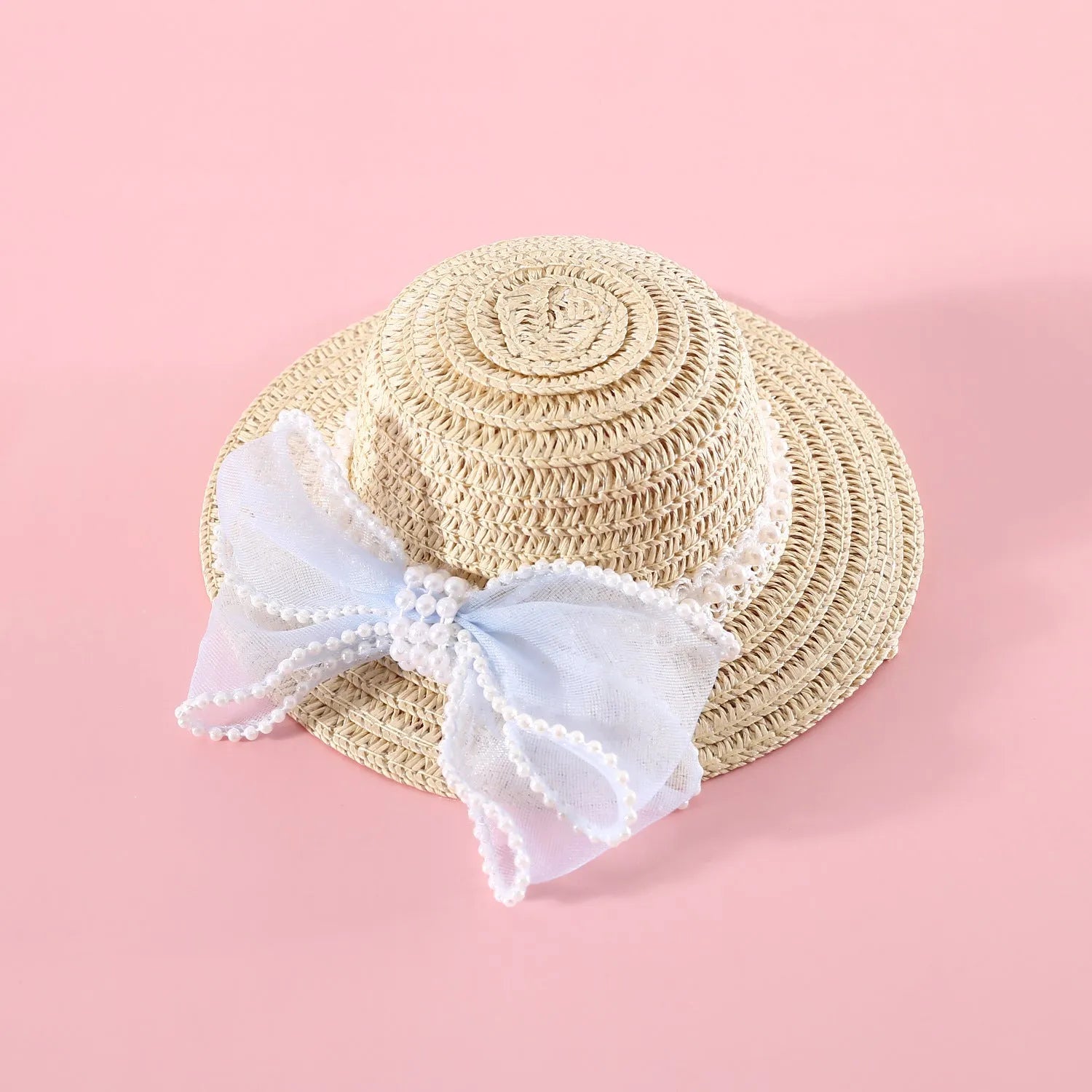Pink pearl bow woven straw hat for a cat, shown in size S (13cm) on a mannequin head.