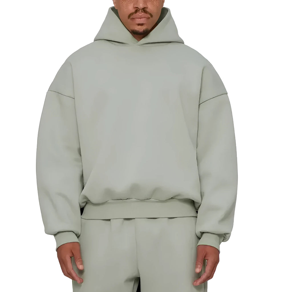 A man wearing a grey fleece-lined cotton pullover hoodie with a wool lining.