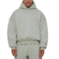 A man wearing a grey fleece-lined cotton pullover hoodie with a wool lining.