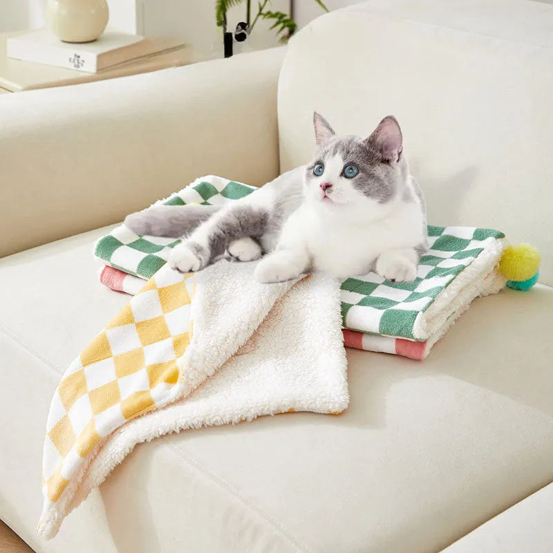 Soft plush pet blanket with plaid pattern and fur ball decoration for cats and dogs