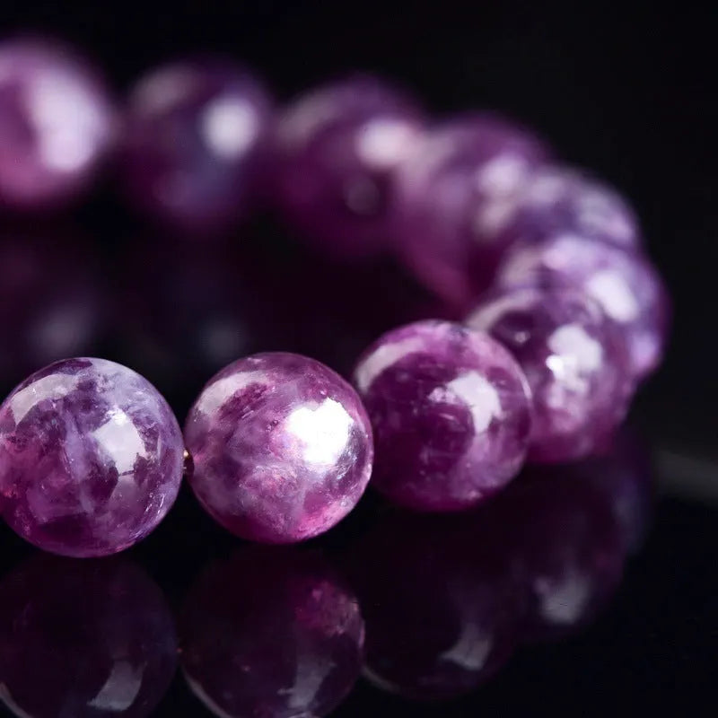 Polished purple and pink crystal grandmother bracelet with geometric beads on a wrist, showing Korean-style unisex design.