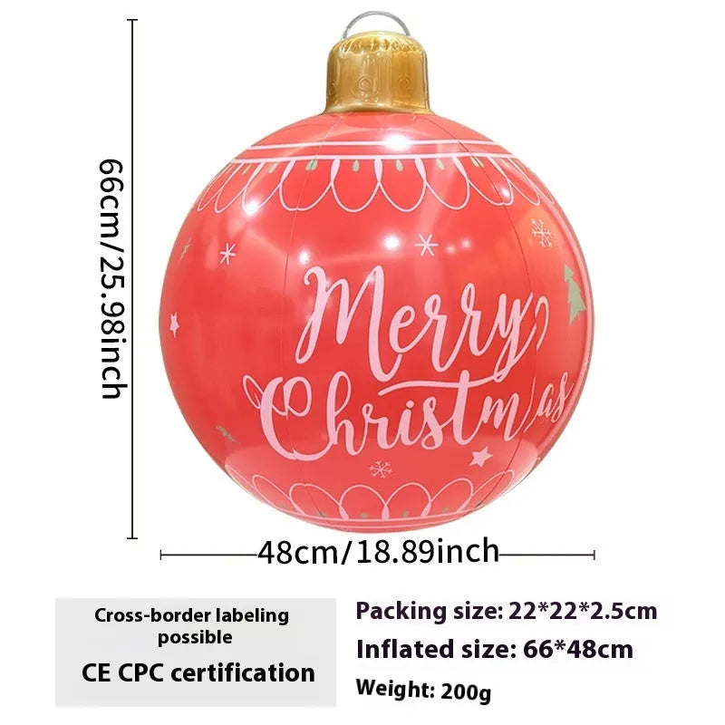 Large red and white inflatable Christmas ball with flashing lights standing in a garden.
