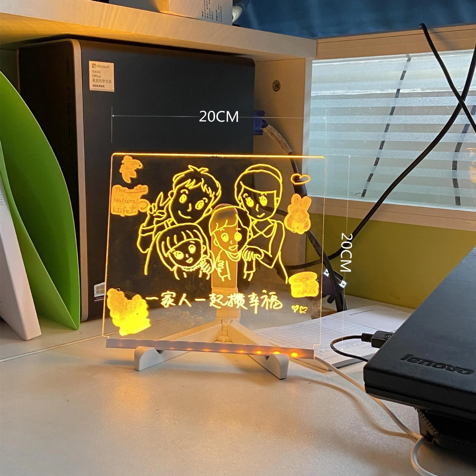 DIY acrylic message board LED night light on desk with colourful writing, USB cable, and pens