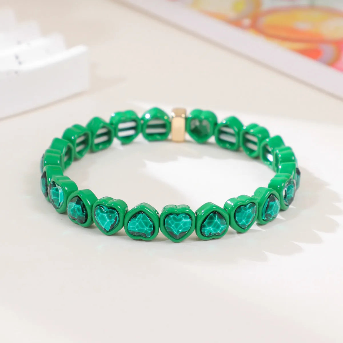 Rainbow enamel heart charm bracelet on alloy base with diamond treatment, stretch band, multicolour design.