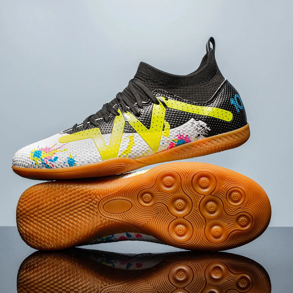 Low-top black and yellow football trainers with a spiked rubber sole and mesh detail.