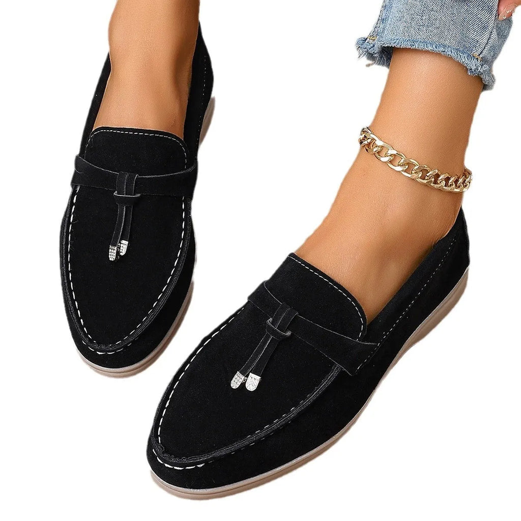A pair of solid-colour platform slip-on loafers with a round toe and canvas upper.