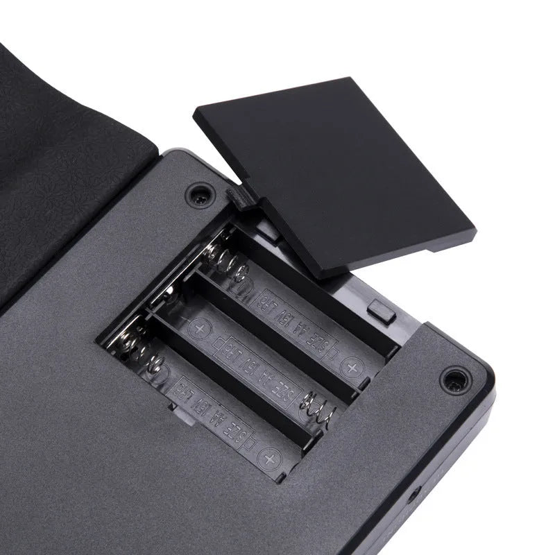 Pearlescent white folding electronic keyboard with 49 silicone keys, shown rolled and unrolled.