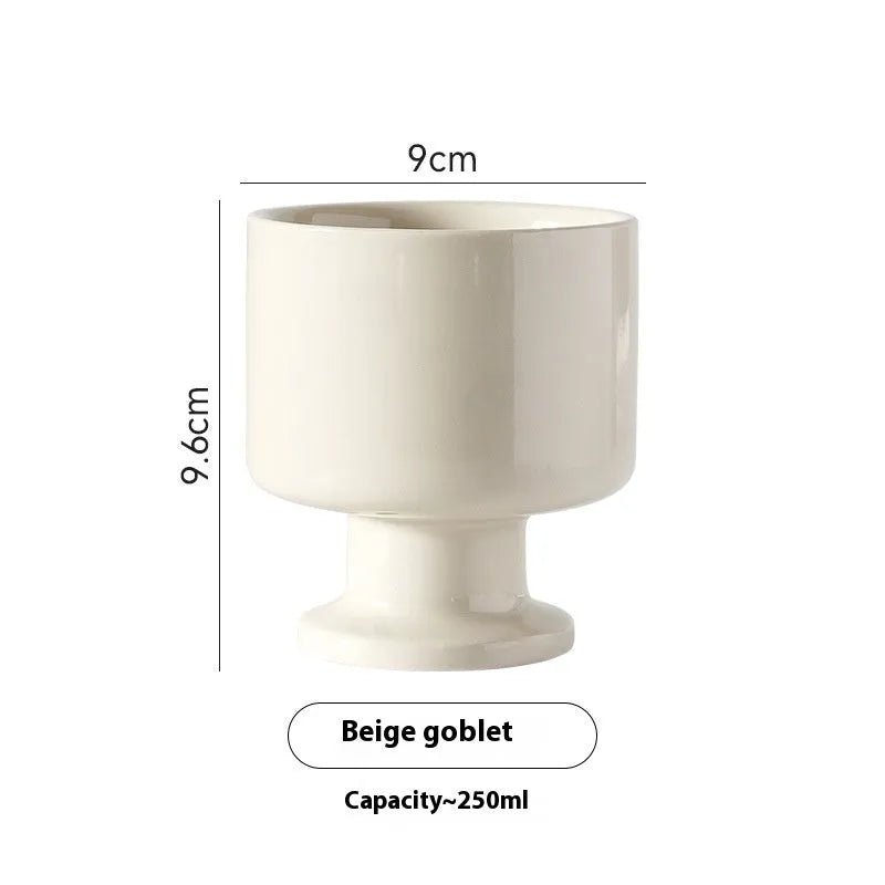 Hand-pinched irregular ceramic mug in a solid colour, showing its unique shape and modern design.