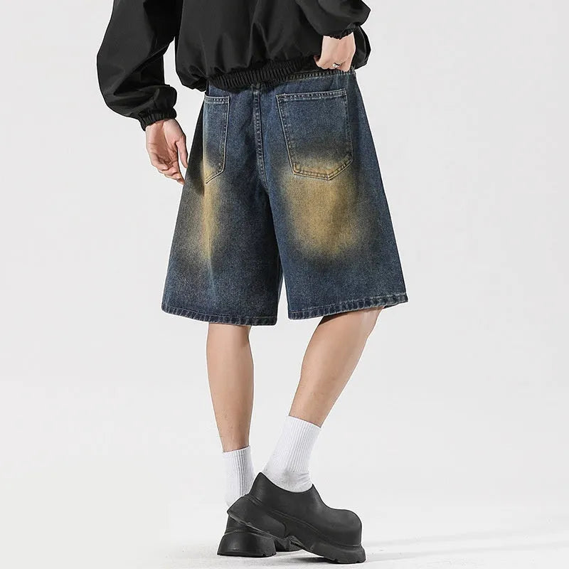 A pair of retro blue loose fit men's jeans with ripped detailing on the legs.