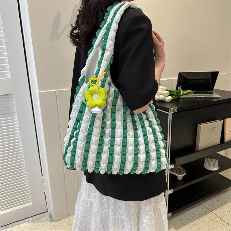 Women's soft pleated bubble shoulder bag in a vertical square shape with a detachable pendant charm.
