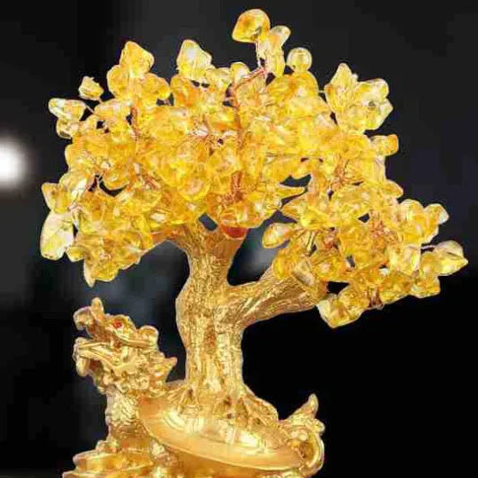 A citrine-coloured resin decorative ornament of a small water turtle and a money tree in Chinese style.