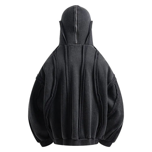 Black loose-fit zip-up hooded coat with an abstract pattern and padding worn as an autumn layer.